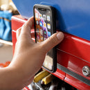 Phone snapped onto a metal toolbox with the FAB POPS Anywhere Grip