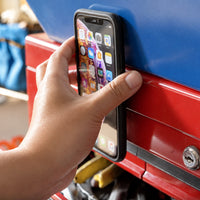 Phone snapped onto a metal toolbox with the FAB POPS Anywhere Grip